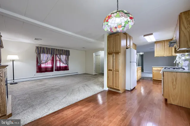 a view of a kitchen with furniture and wooden floor