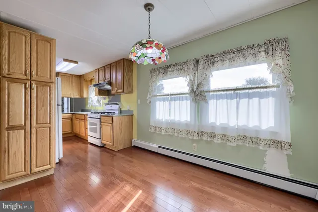 a kitchen with a sink cabinets and wooden floor