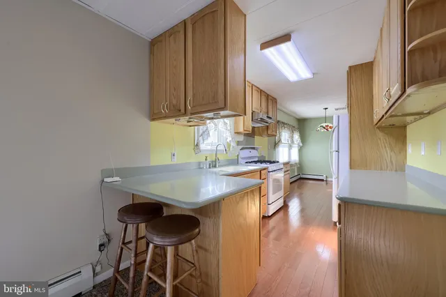 a kitchen with stainless steel appliances granite countertop a stove a refrigerator and a sink