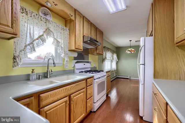 a view of kitchen with furniture and refrigerator