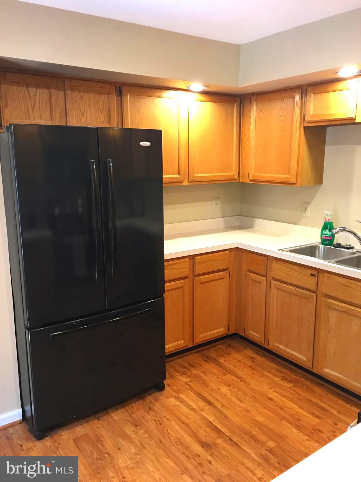 43506 Postrail Square Ashburn, VA 20147 - Photo 15 of 59 Laminate wood floors in kitchen for easy clean up