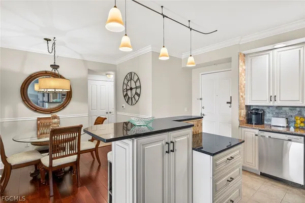 a kitchen with stainless steel appliances kitchen island granite countertop a stove a sink a refrigerator and a microwave