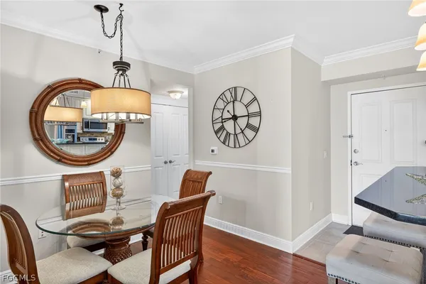 a dining room with furniture a rug and a mirror