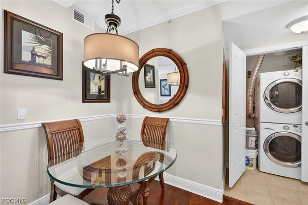 a living room with furniture a large window and a rug