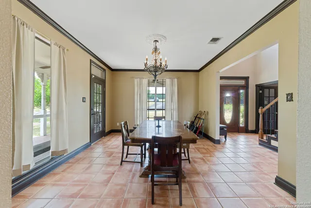 a view of a dining room with furniture and chandelier