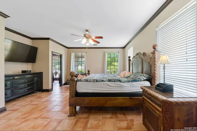a bedroom with furniture and a flat screen tv