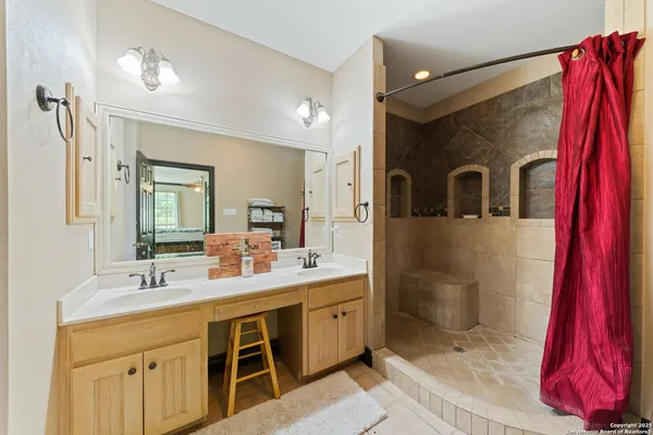 a bathroom with a sink vanity and mirror