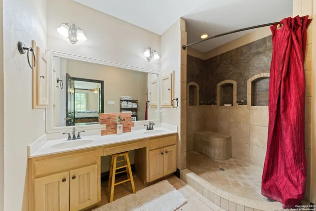 a bathroom with a sink vanity and mirror