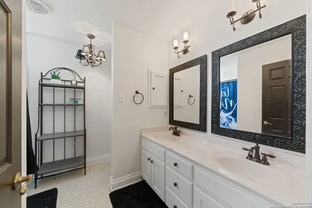 a bathroom with double vanity sink and a mirror