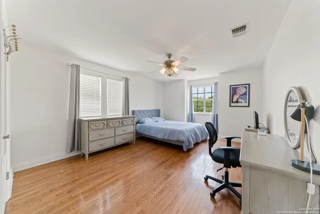 a bedroom with furniture and a wooden floor
