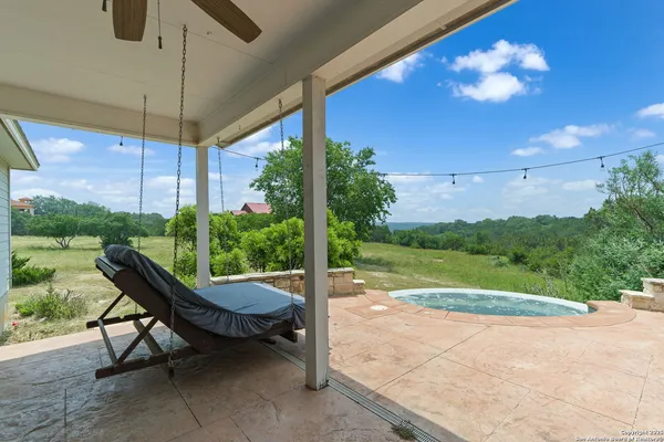 a view of a patio with a table chairs and a backyard