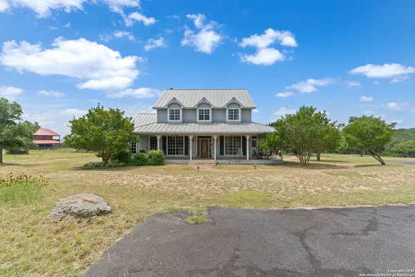 a front view of a house with a big yard