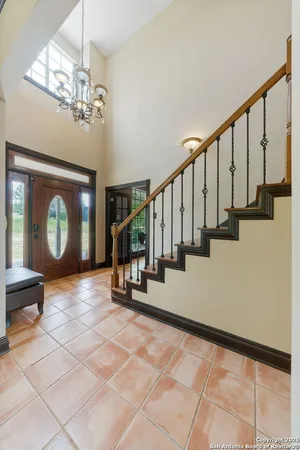 a view of a livingroom with wooden floor and a staircase