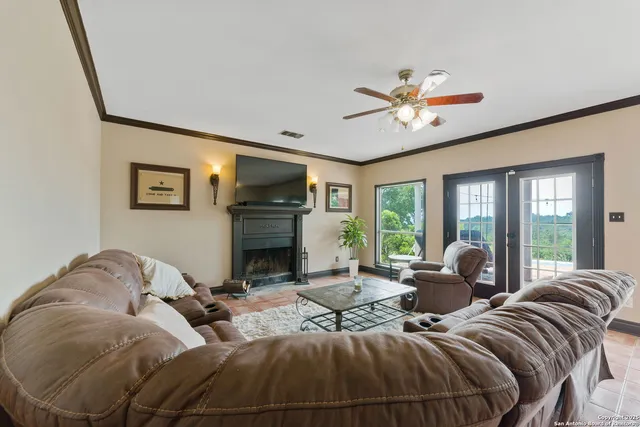 a living room with furniture large window and a fireplace