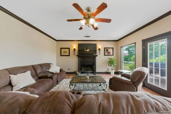a living room with furniture fireplace and a large window