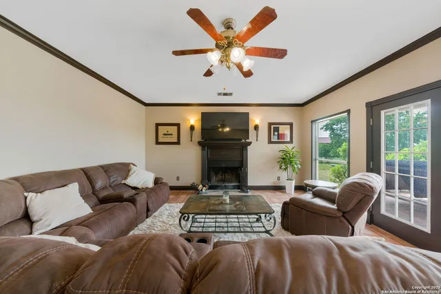 a living room with furniture fireplace and a large window