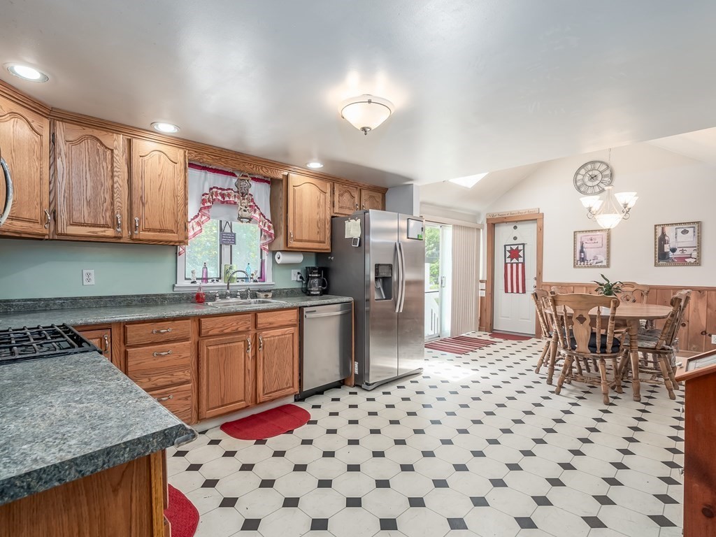 20 Rangeway Road Billerica, MA 01862 - Photo 7 of 41 a kitchen with granite countertop a sink stove and cabinets