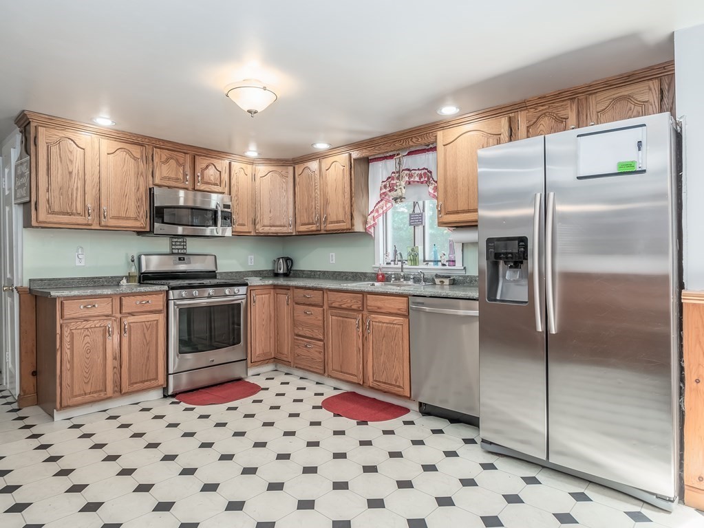 20 Rangeway Road Billerica, MA 01862 - Photo 8 of 41 a kitchen with granite countertop a refrigerator and a sink