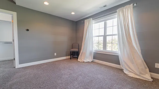 a bedroom with furniture and white walls