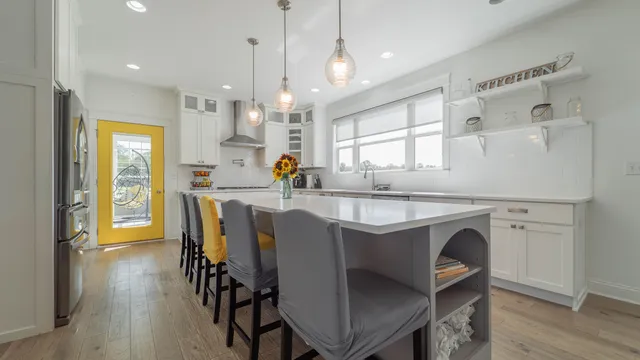 a kitchen with white cabinets and stainless steel appliances