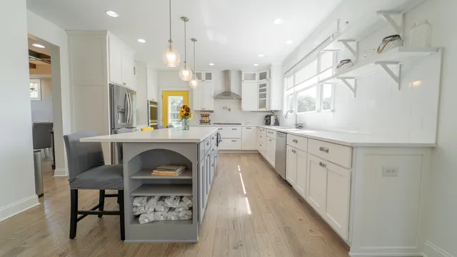 a living room with furniture a fireplace and a large window