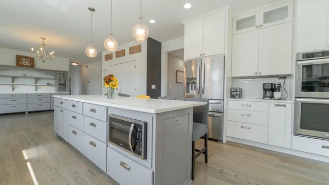 a living room with furniture a large window and bookshelf