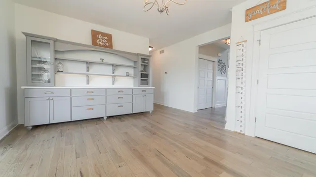 a living room with a fireplace furniture a ceiling fan and a large window