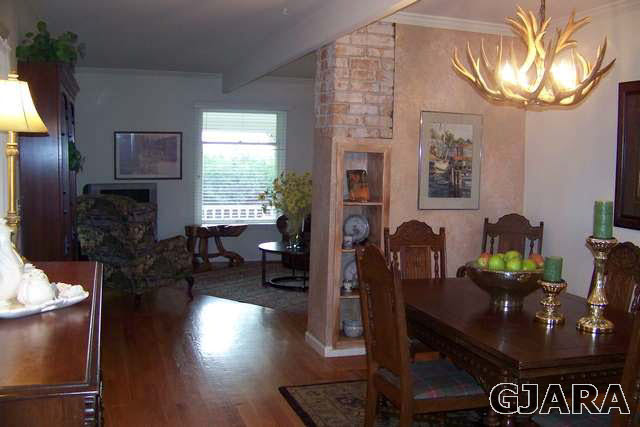 3530 G Road Palisade, CO 81526 - Photo 11 of 25 a living room with furniture a lamp wooden floor and a large window