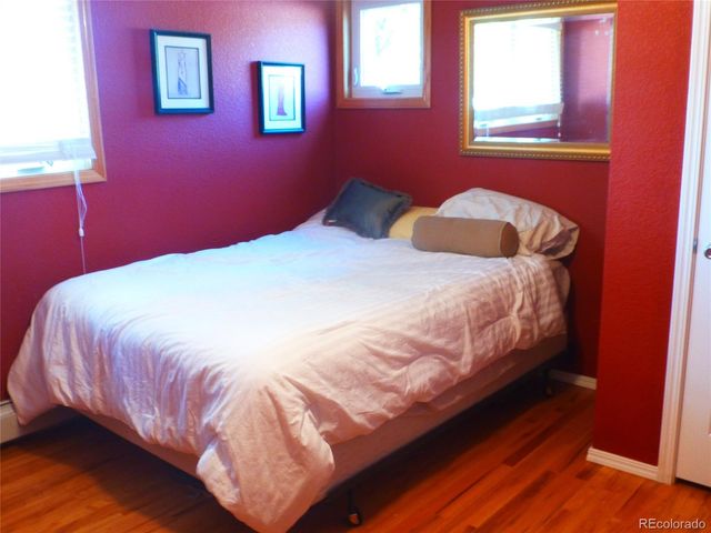 a bedroom with a bed and a lamp