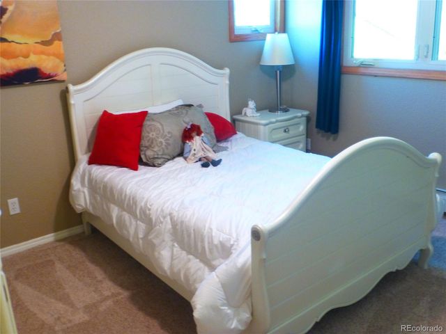 a view of a porch with chairs and floor to ceiling window