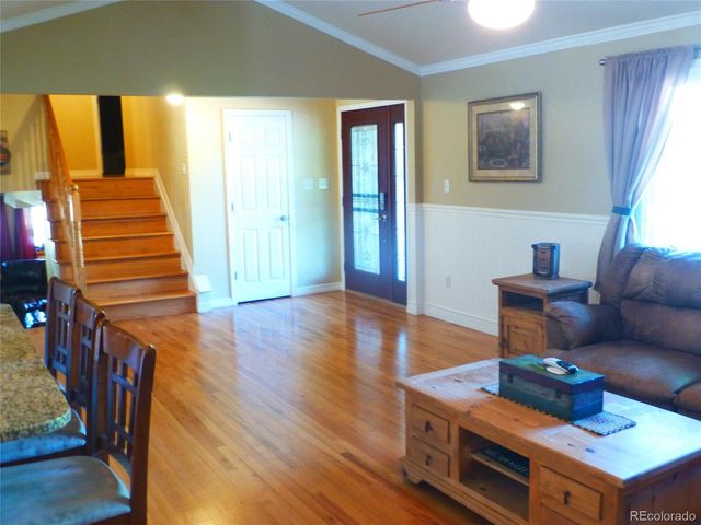 a living room with furniture a window and a chandelier