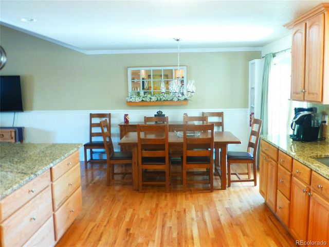 a kitchen with granite countertop a stove a sink and a microwave