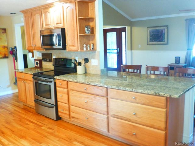 a kitchen with stainless steel appliances granite countertop counter space a sink and cabinets