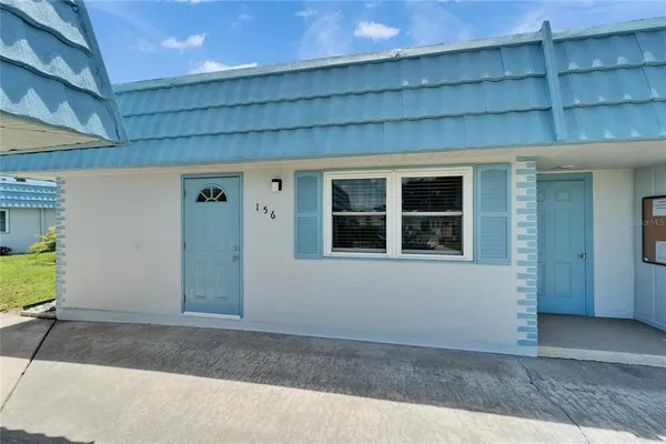 a view of a house with a yard and garage