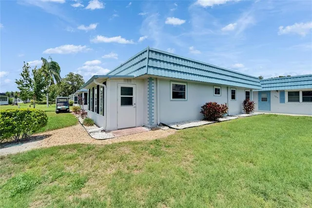 a front view of house with yard and green space