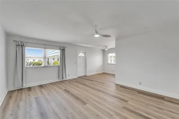 wooden floor in an empty room with a window