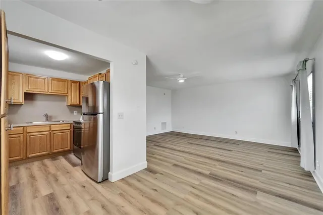 a kitchen with a refrigerator and a stove top oven