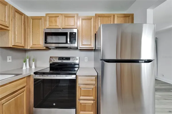 a kitchen with a refrigerator stove and microwave
