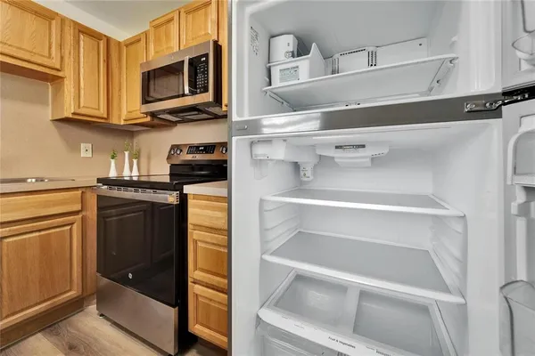 a kitchen with white cabinets and black appliances