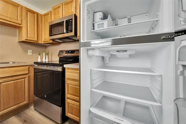 a kitchen with white cabinets and black appliances