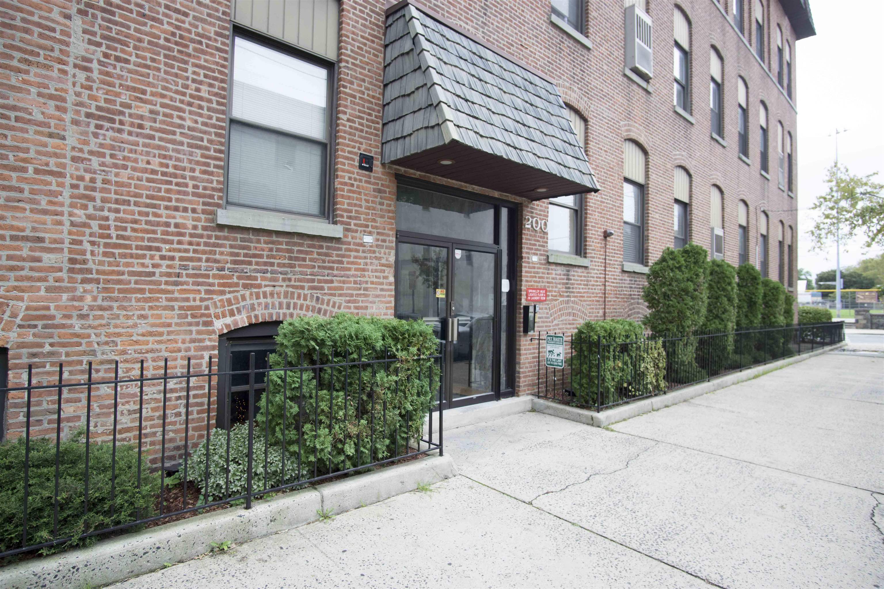 a view of a brick house with plants