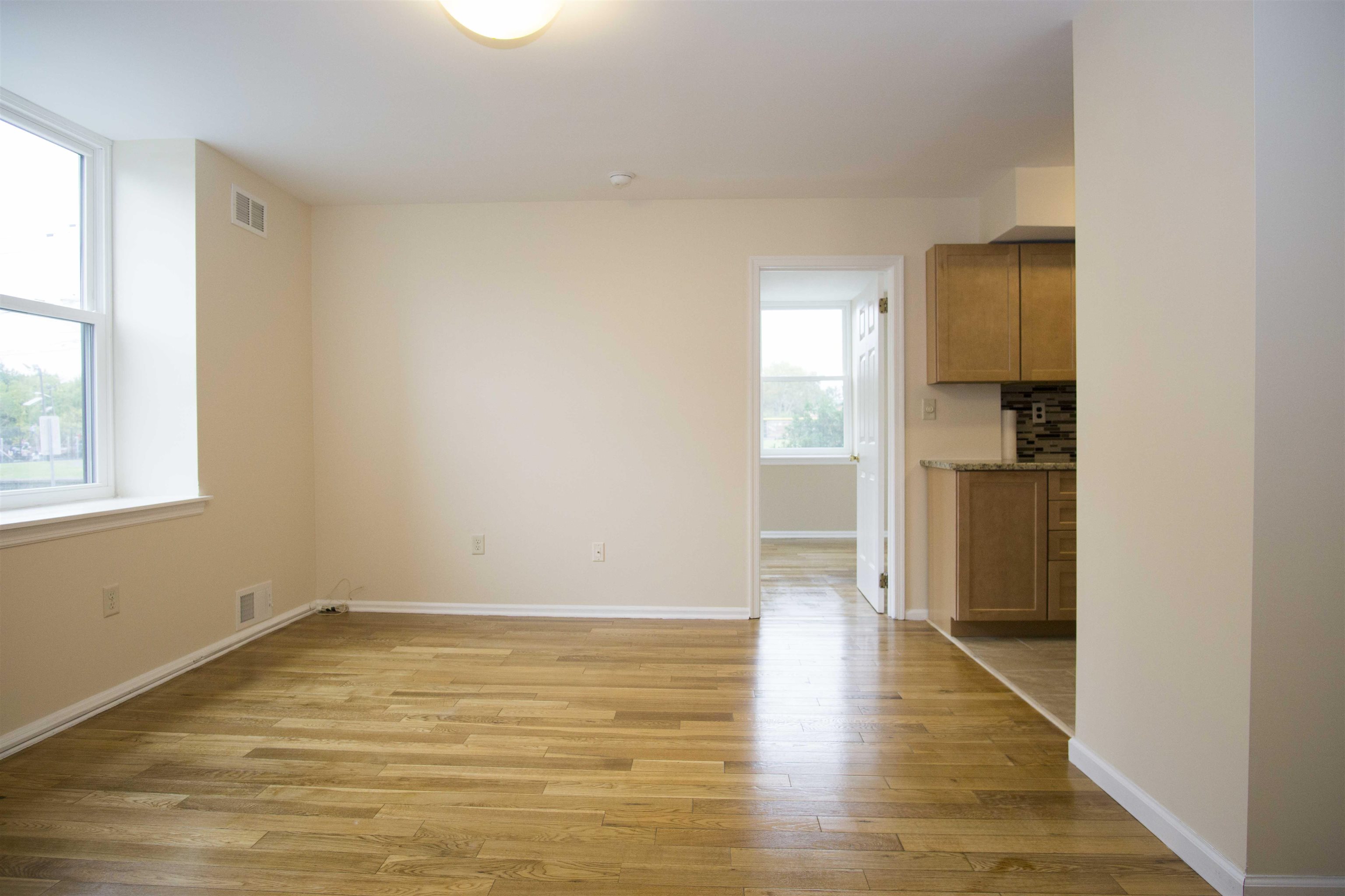 200 Central Avenue, Unit B5 Jersey City, NJ 07307 - Photo 2 of 12 a view of an empty room with wooden floor and a window