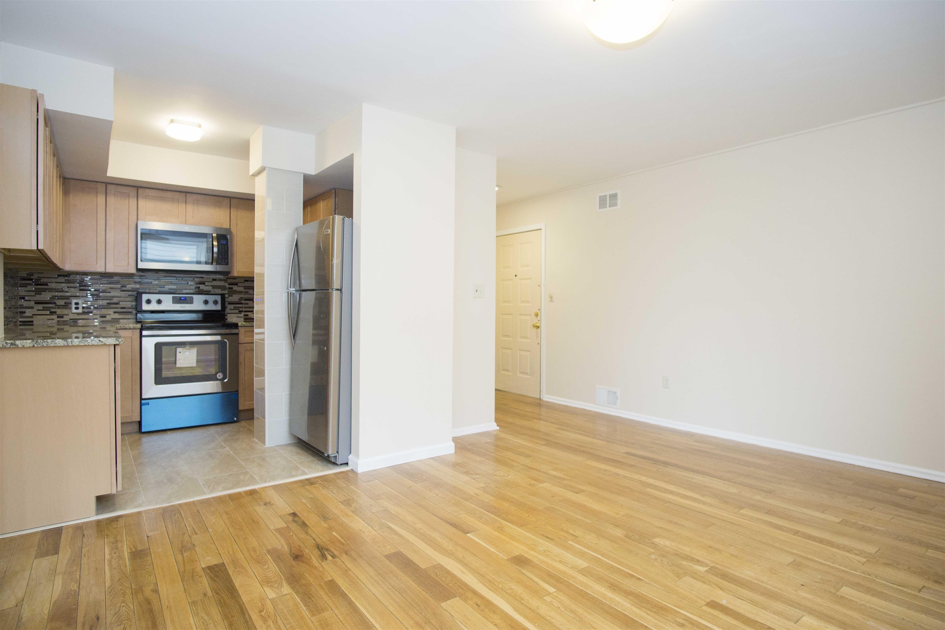 200 Central Avenue, Unit B5 Jersey City, NJ 07307 - Photo 3 of 12 a kitchen with stainless steel appliances a refrigerator and a stove top oven