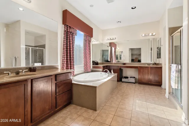 a bathroom with a tub sink and mirror