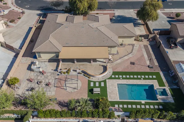 an aerial view of a house with yard and garage