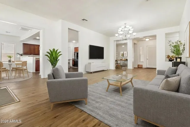 a living room with furniture or chandelier and a wooden floor