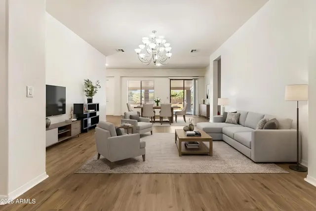 a living room with furniture and a chandelier