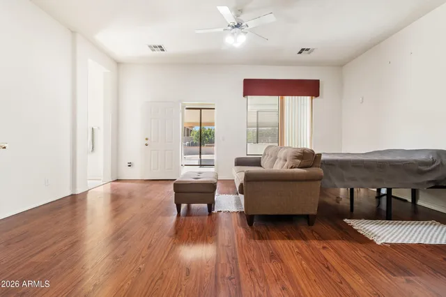 a living room with furniture and wooden floor