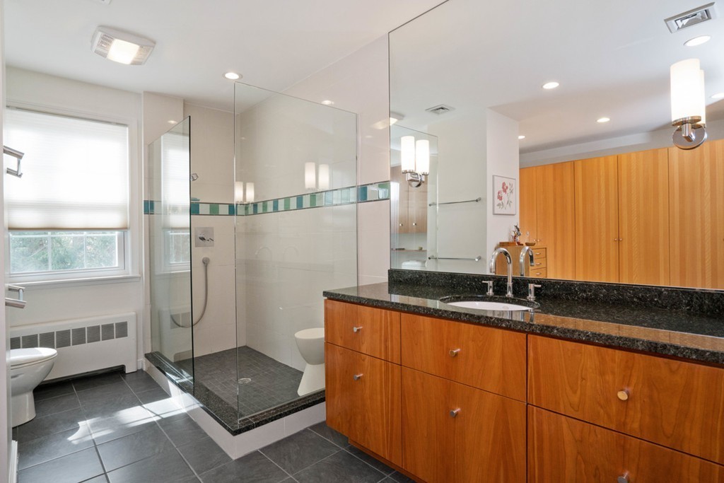 51 Baskin Road Lexington, MA 02421 - Photo 13 of 28 a bathroom with a granite countertop sink a toilet and shower