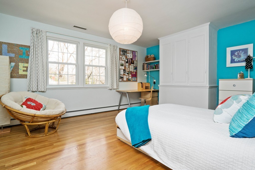 51 Baskin Road Lexington, MA 02421 - Photo 14 of 28 a spacious bedroom with a bed and a chandelier